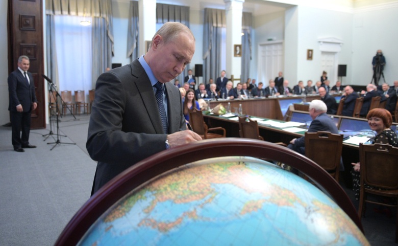 Владимир Путин расписывается на поверхности хранящегося в РГО глобуса. Фото: kremlin.ru