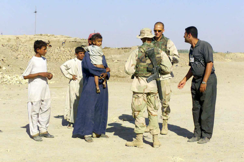 Американские солдаты в Ираке общаются с местными жителями через переводчика (справа). В ходе иракской войны переводчики-иракцы гибли в 10 раз чаще, чем военнослужащие коалиции.