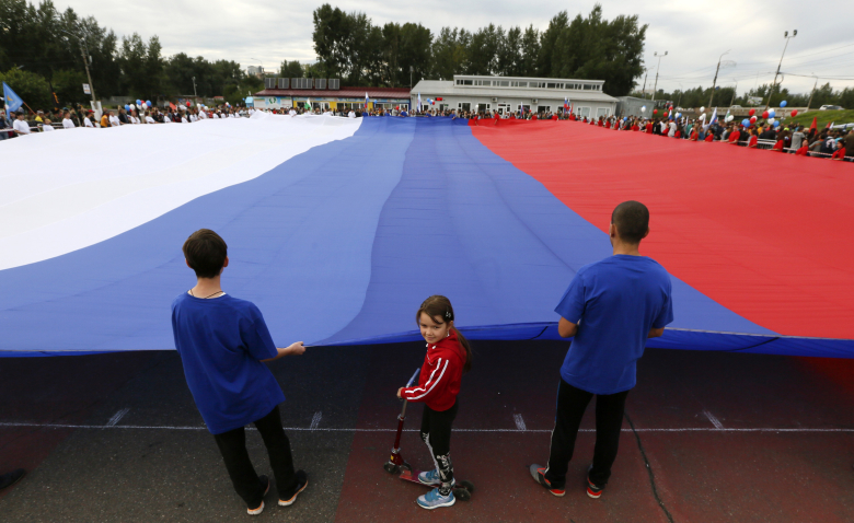 Празднование Дня государственного флага Российской Федерации в Красноярске. Фото: Ilya Naymushin / Reuters