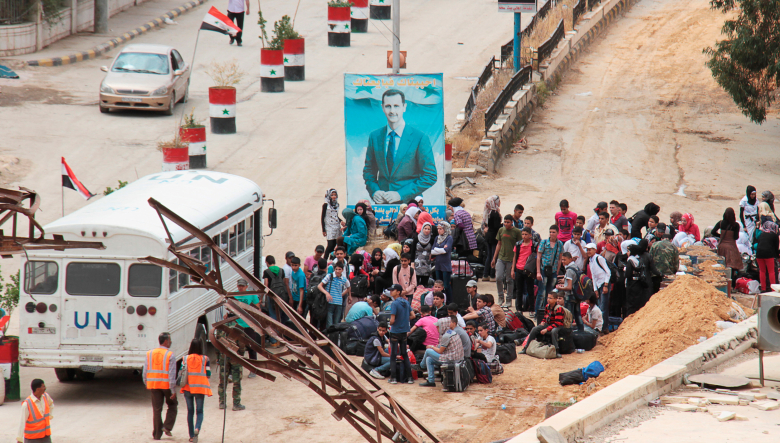 Автобус у контрольно-пропускного пункта в пригороде Дамаска, контролируемого силами, лояльными президенту Башару аль-Асаду .